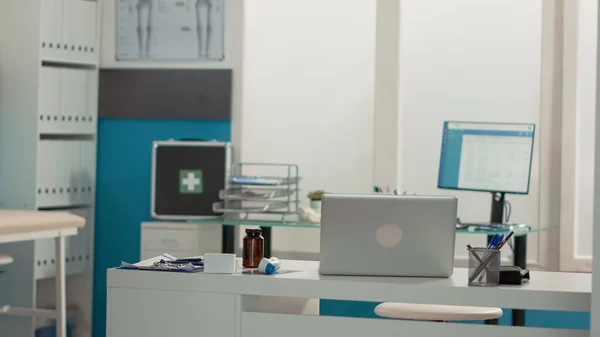 Mesa de escritório vazia com laptop e instrumentos médicos — Fotografia de Stock