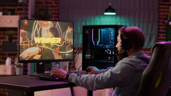 Man gamer teaching his girlfriend playing space shooter video game on RGB  powerful personal computer. Pro cyber woman with headset performing video  games streaming from home during online tournament Stock Photo 