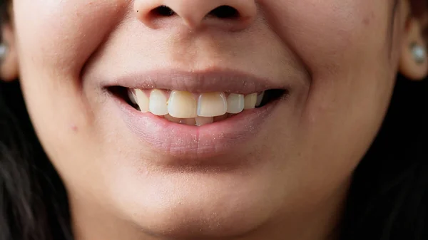 Macro shot of positive indian person smiling in front of camera — Stockfoto