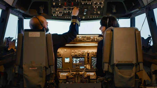 Male captain fixing altitude and longitude levels to fly airplane — Stock Photo, Image