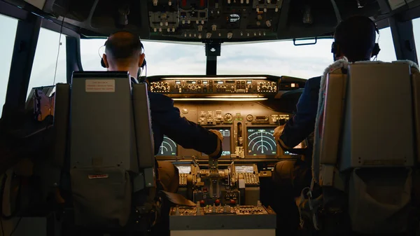 Captain and copilot throttling engine handle to fly airplane