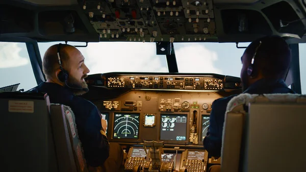 Diverse team of captain and copilot using dashboard command — Stock Photo, Image