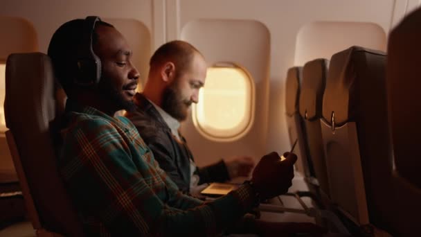Passageiro masculino conversando com comissário de bordo em avião — Vídeo de Stock