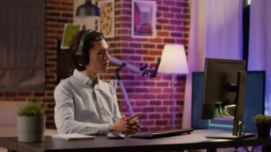 Uzaktan ders dinleyen serbest çalışan bir erkek ya da iş kurmayı öğrenmek için bilgisayarda webinar eğitimi alan biri. Uygulama raporunu planlamak için kablosuz kulaklıkla podcast çalışması kullanılıyor.