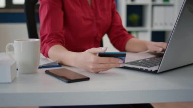 Business woman using credit card to buy on online shopping from retail store, making internet payment for e commerce development. Sales consultant doing purchase with money transaction. Close up.