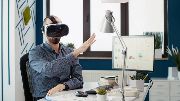 Sales consultant working with vr goggles for business growth, using virtual reality headset with 3d interactive simulation. Research assistant analyzing sales diagram presentation.