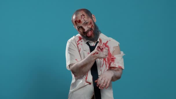 Creepy Looking Zombie Showing Thumbs Hand Gesture Blue Background Approving — Stockvideo