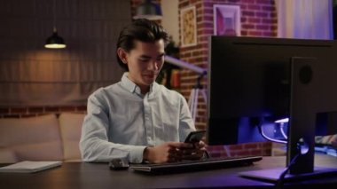 Asyalı ofis çalışanının portresi çevrimiçi web sitesi uygulamasına evrak bilgileri yazıyor, e-posta raporu yazmak için bilgisayarı kullanıyor. Ticari ağda çalışmak için internete göz atıyorum. El kamerasıyla..