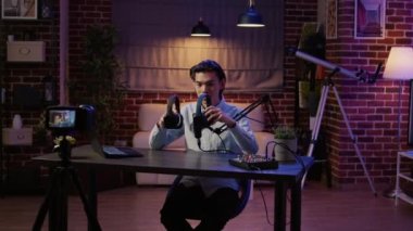 Lifestyle influencer doing product review with headphones on podcast show, recording video and recommending wireless headset. Filming vlog live broadcast on channel for audience.