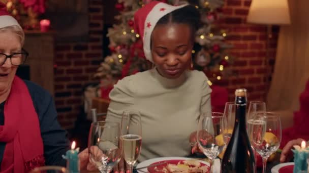 Festive Family Members Wearing Feast Hats While Enjoying Christmas Dinner — Vídeos de Stock