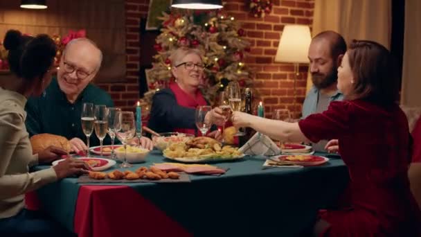 Festive Diverse People Clinking Glasses While Enjoying Christmas Dinner Table — Wideo stockowe