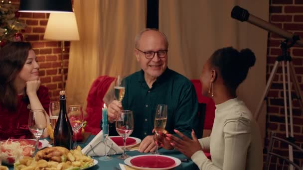 Festive Smiling Senior Man Clinking Glasses Young Woman Christmas Dinner — Stockvideo