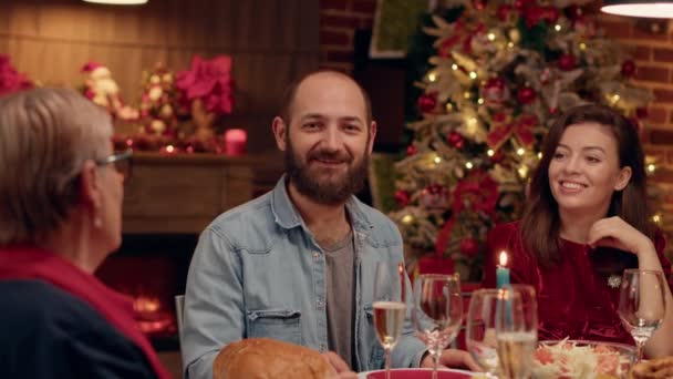 Joyful Husband Smiling Camera While Enjoying Christmas Dinner Loved Ones — Videoclip de stoc