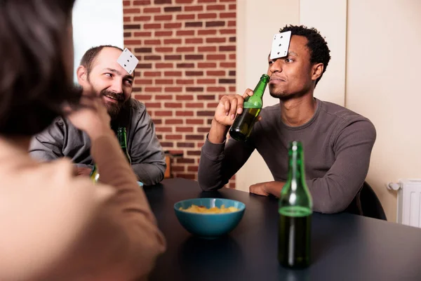 African American Man Playing Guessing Game Cards While Sipping Beer —  Fotos de Stock