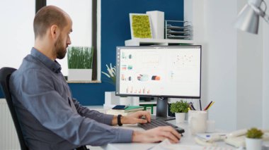 Project manager analyzing business sales charts on computer, working with statistics for financial development. Executive assistant using graphs and diagrams for data research.