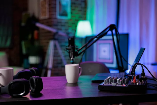 Empty living room prepared to record online podcast show with modern sound equipment and station. Filming live broadcast show with microphone for social media internet content.