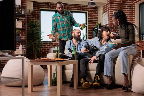 Men and women gathering at house party to play video games, feeling sad and frustrated about losing competition with vr glasses. Group of people having fun with leisure activity, lost gameplay.