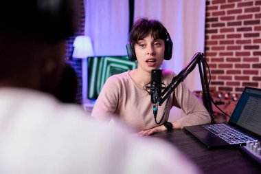 Yaşam tarzı blogcusu kadın konukla konuşuyor, ses ekipmanıyla podcast yapıyor. Neşeli bir kadınla canlı yayında konuşmak ve stüdyoda kayıt yapmak için nüfuz sahibi..