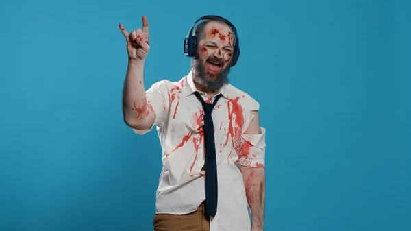 Messy Creepy Zombie Wearing Electronic Wireless Headphones While Listening Music — Fotografia de Stock