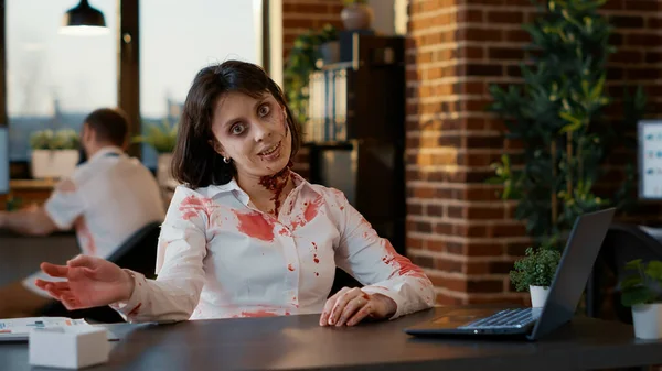 Weird Looking Spooky Zombie Woman Waving Camera While Sitting Office — Fotografia de Stock