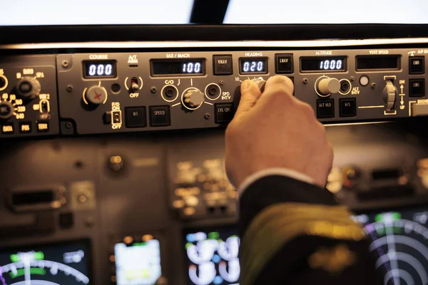 Male pilot pushing buttons to fix altitude level on control panel command, using navigation switch to fly airplane jet. Power radar with dashboard and handle to takeoff with plane. Close up.