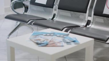No people sitting on chairs in empty hospital reception area during coronavirus pandemic. Nobody in waiting room at medical facility, healthcare service to help with covid 19 epidemic.