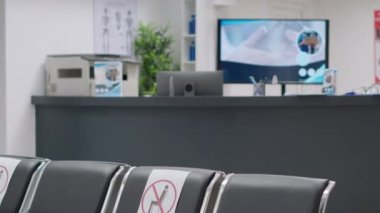 Nobody in hospital reception lobby with empty chairs at healthcare clinic during covid 19 epidemic. No people attending checkup visit appointment at facility waiting room, virus protection.