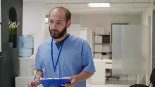 Male Nurse Talking African American Man Waiting Room Lobby Doing — Wideo stockowe