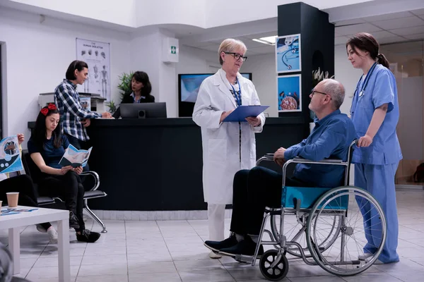Retired Person Using Wheelchair Talking Senior Doctor Appointment While Being — Stock Photo, Image