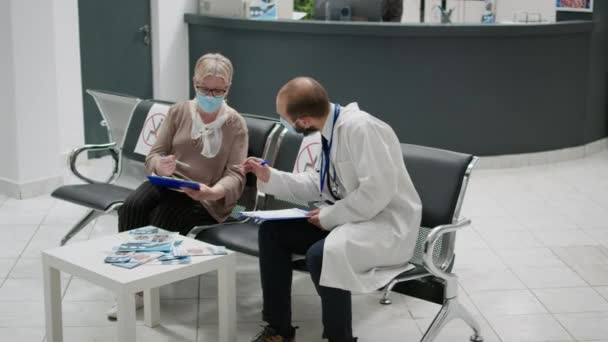 Physician Senior Woman Face Masks Talking Waiting Area Filling Medical — Stockvideo