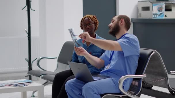 African American Patient Male Nurse Looking Ray Scan Sitting Waiting — Stock video