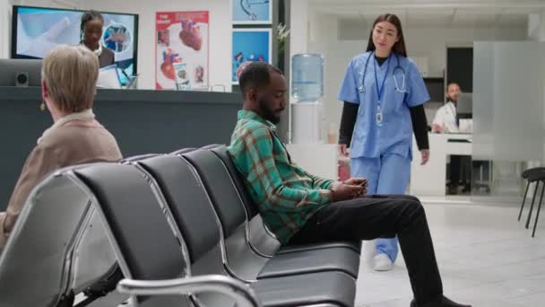 African American Patient Going Medical Office Asian Nurse Attend Checkup — Wideo stockowe