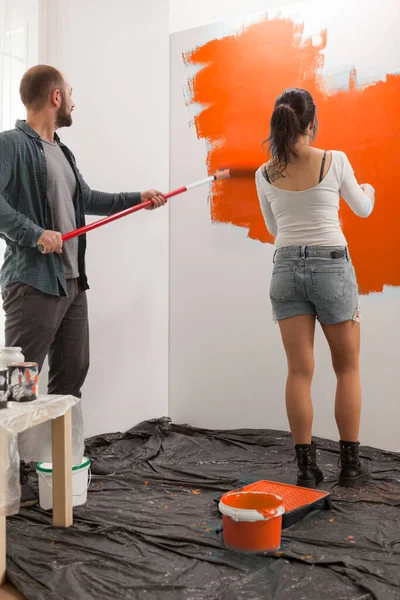 Young Family Using Orange Color Paint Renovate Apartment Walls New — 图库照片