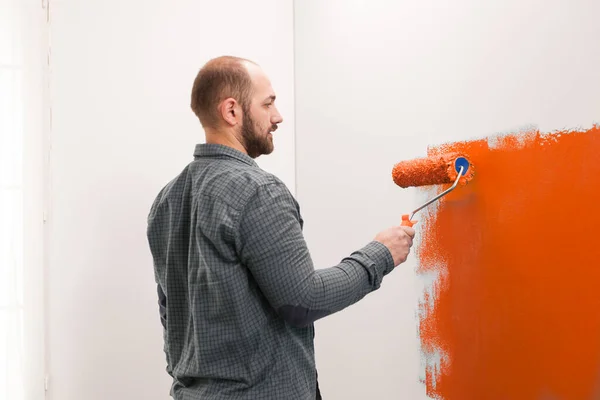 Male Painter Doing Housework Orange Paint Renovating Apartment Walls Vibrant — 图库照片