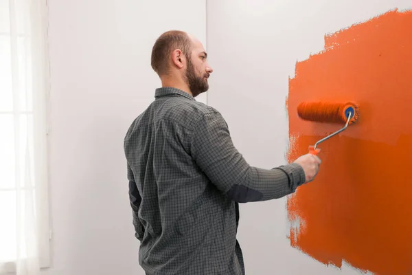 Man Renovating Apartment Orange Paint Using New Color Living Room — Stok fotoğraf