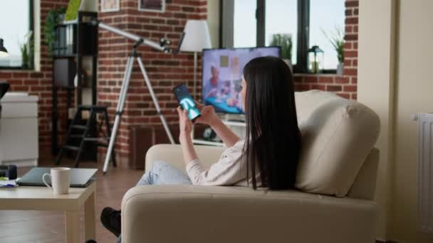 Childish Young Adult Person Enjoying Mobile Gaming While Sitting Sofa — Αρχείο Βίντεο