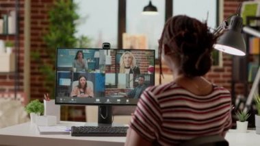 Office worker using online videocall conference to talk to colleagues, chatting on remote videoconference with webcam and computer. Female freelancer talking on teleconference chat.