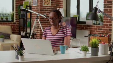 Young freelancer doing remote distant work on laptop computer, using internet connection at home. Employee working remotely on freelance network, digital online network on pc. Modern job.