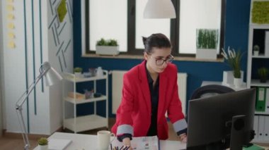 Project manager looking at statistics on papers and computer, planning financial analysis with charts and graphs. Company consultant using data research to work on business growth.
