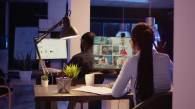 Executive assistant attending business meeting on videocall conference, talking to colleagues on online teleconference call. Using remote videoconference communication to chat on webcam.