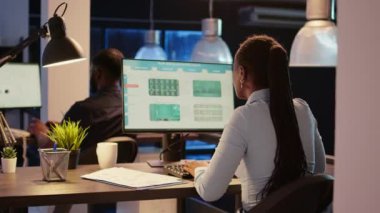 African american woman working with business web 3.0 app, using search text application page with navigation in office with big windows. Analyzing network information on computer, www website.