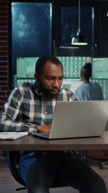 Vertical video: Stressed sales trader having problem with forex exchange investment, feeling upset about trade market numbers. Disappointed about financial stock charts and graphs on laptop, making
