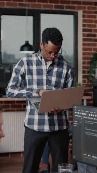 Vertical Video Portrait African American Programer Standing Working Laptop Looking — ストック動画