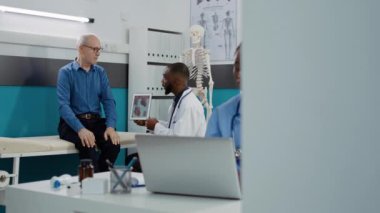 Medic showing cardiology diagnosis on digital tablet to old patient, explaining cadiogram and heart organ disease. Illustration of cardiovascular system test results to find healthcare treatment.