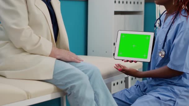 Medical Assistant Holding Digital Tablet Greenscreen Display Doing Checkup Visit — Vídeos de Stock