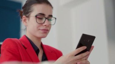 İnternet 'e bakmak için akıllı telefonu kullanan satış danışmanı, iş büyümesi için çevrimiçi pazarlama istatistikleriyle çalışıyor. Bir kadın cep telefonu uygulamasını kontrol ediyor. El kamerasıyla. Kapat..