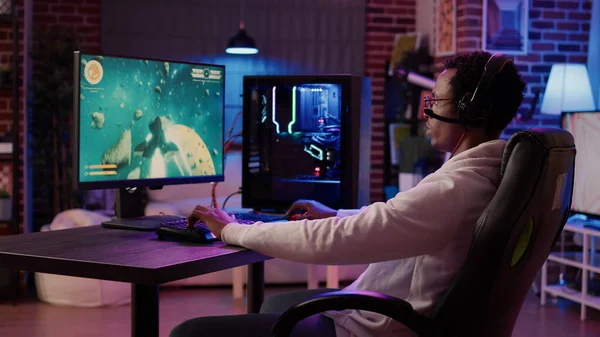 Premium Photo  Happy person live streaming video games tournament online  with multiple players, playing action esport game on computer. male  streamer with headset enjoying gaming competition.