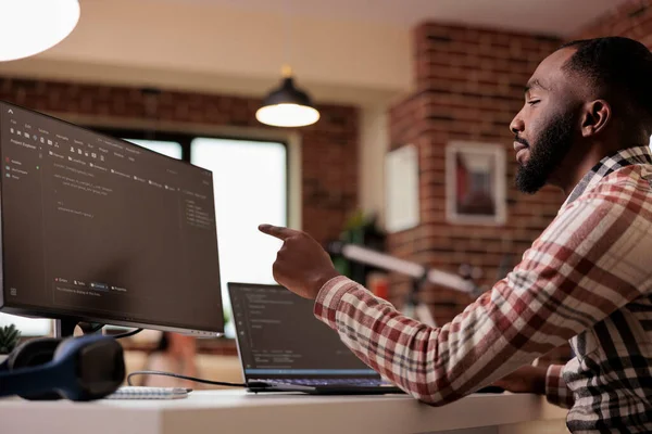 Web developer writing program code and html data base on new user interface. Male freelancer using terminal window and developing online app cloud server, learning coding language.