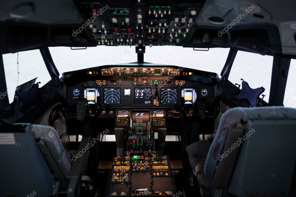 Nobody in airplane cockpit with electronic flying navigation panel, control command with buttons and lever on dashboard. No people in aircraft cabin to throttle engine and takeoff.