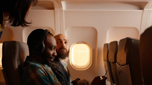 Male Passenger Talking Flight Attendant Airplane Being Seated Plane Using — Fotografia de Stock